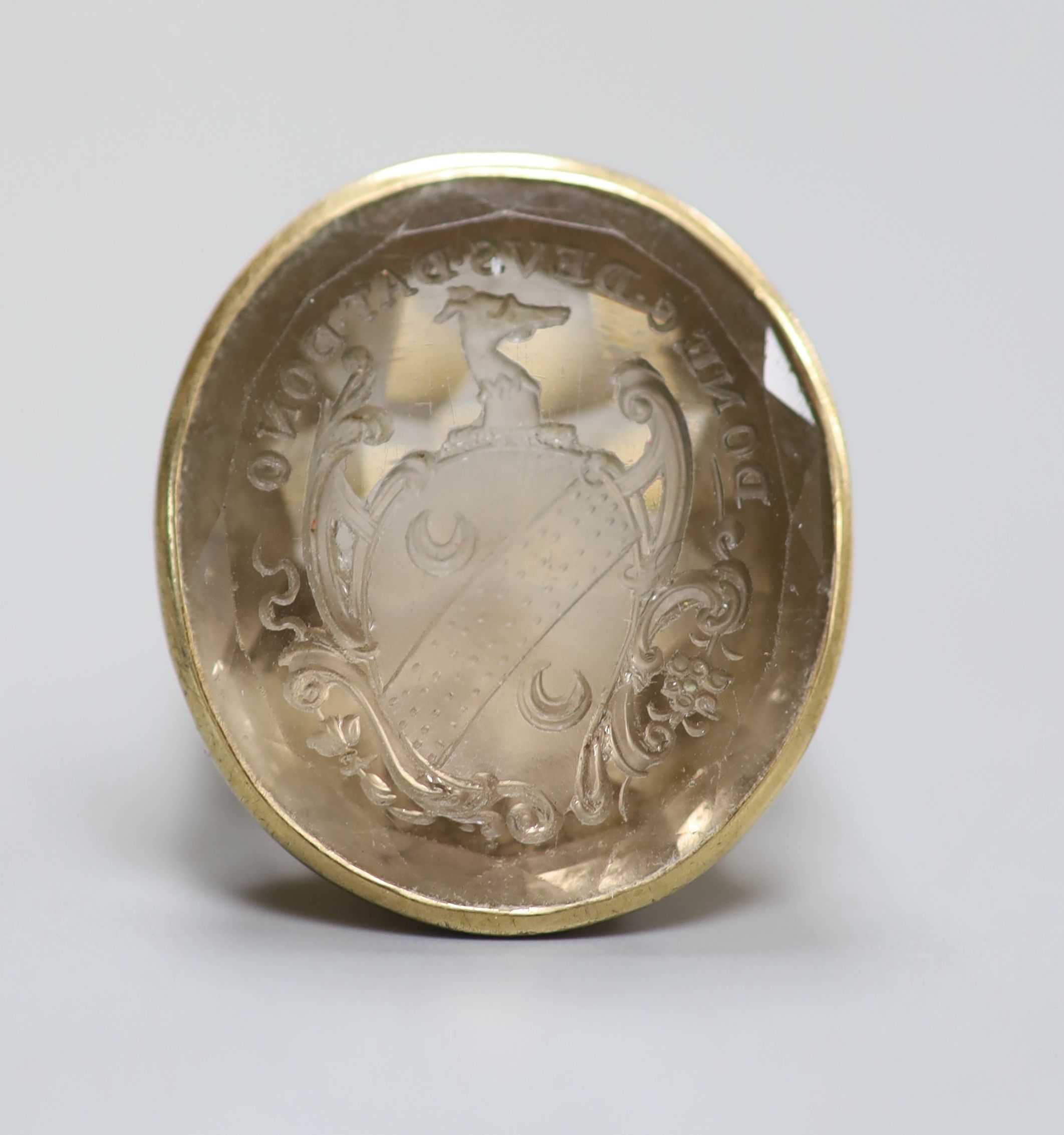 A 9ct and oval citrine set seal ring, the matrix carved with motto and crest